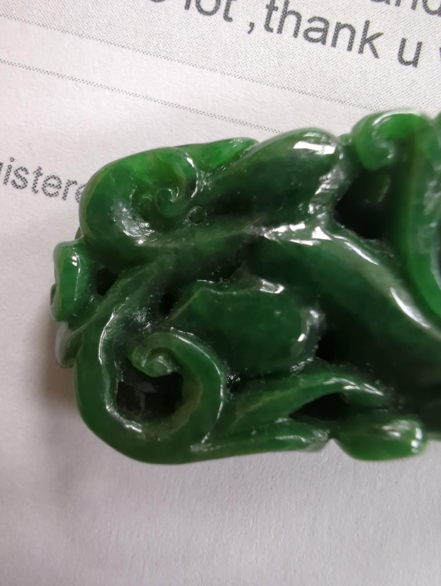 A Chinese Jadeite carving of two cash and a chilong, 3.7cm